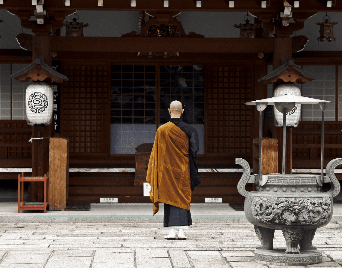 Buddhist monk in front of temple in Kyoto, Japan