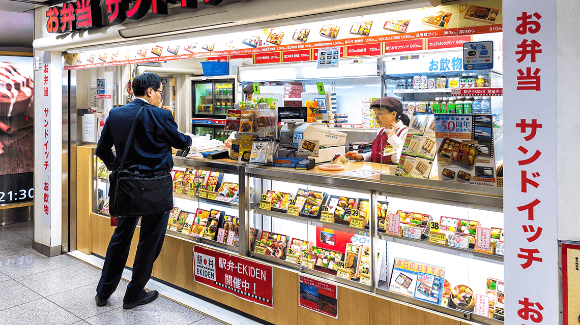 A commuter purchases an ekiben (station bento) from Tokyo Station before travelling on the shinkansen (bullet train) A commuter purchases an ekiben (station bento) from Tokyo Station before travelling on the shinkansen (bullet train)