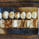 Grilled skewers of yakitori with chicken and garlic in Japan