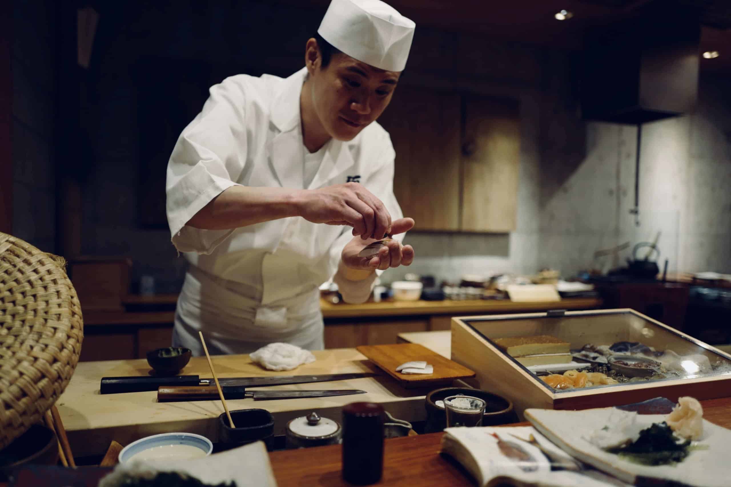 Japanese chef prepares sushi