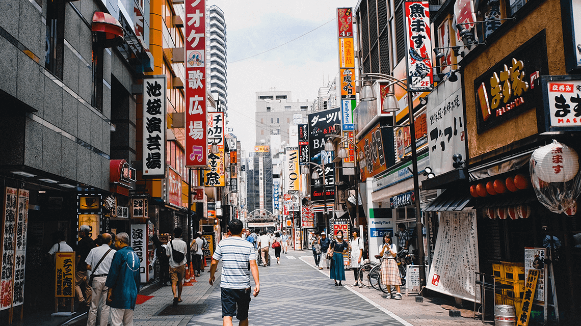 A bustling street with lots of Japanese signs in Tokyo, Japan A bustling street with lots of Japanese signs in Tokyo, Japan